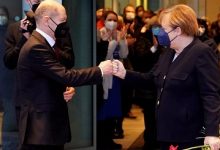 • Olaf Scholz bidding Angela Merkel goodbye and thanking her