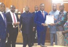 • Mr Boahen Aidoo (fourth from right) receiving the citation and plague from Mr Osei Asante while management of COCOBOD and executive of the GhCCI look on