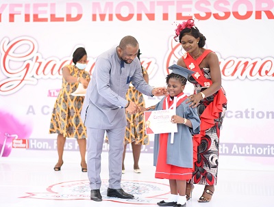 Mr Pius Hadzide (left) presenting a certificate to one of the pupils. With them is Ms Magdalene Dzifa Adzanu