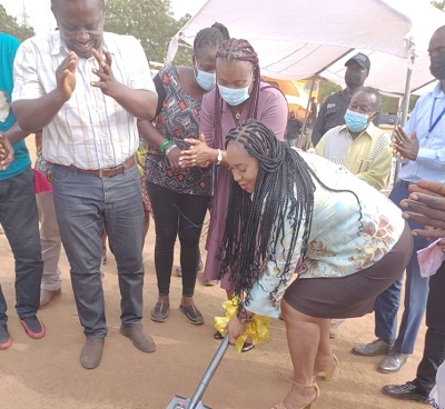 • Ms Safo cutting the sod for works to start on the court complex