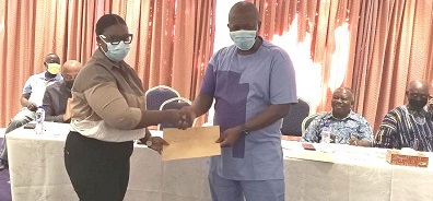 • Ms Doreen Ampadu, an electrical engineer, receiving her certificate from CEO of GRIDCo, Mr Ebenezer Essienyi