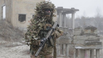 • A Ukrainian soldier wearing camouflage while taking part in drills