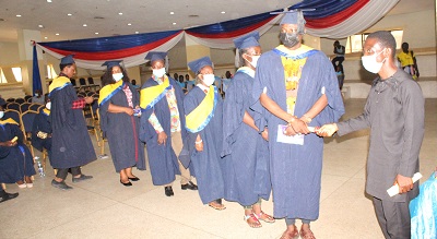 • Some of the graduands taking their certificates at the graduation ceremony. Photo: Ebo Gorman