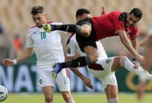 Egypt's Amr El Solia battles for the ball with Morocco's Munir El Haddadi and Selim Amallah