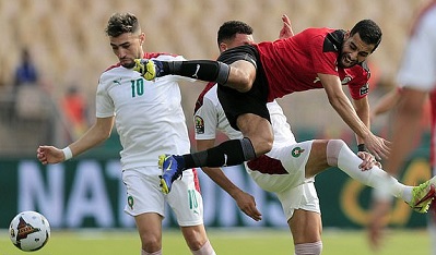 Egypt's Amr El Solia battles for the ball with Morocco's Munir El Haddadi and Selim Amallah