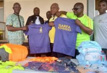• Mr Quao (second left) presenting of the shirts to Mr Lomotey (third right)