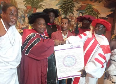 • Nii Ayi-Bonte II (second from left) receiving the citation accompanying the award from the leadership of the college