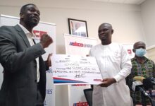 • Mr. Acheampong Kyei (left) presenting the dummy cheque to Mr. Ussif