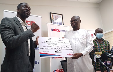 • Mr. Acheampong Kyei (left) presenting the dummy cheque to Mr. Ussif