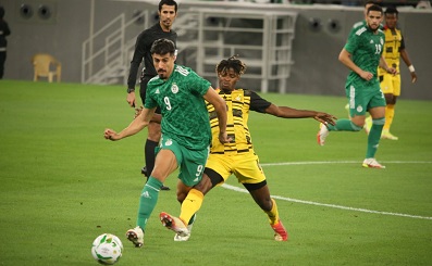 • Ghana's Edmund Addo challenges an Algerian player in yesterday's game