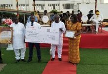 • Dr Moses Siaw Frimpong, picking GH¢15,000.00 dummy cheque for the first position. With him are Dr Oheneba Owusu-Danso, KATH Chief Executive, Chief Coordinator, RCC, Ms Botchway