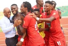 Kotoko's Mfegue (shirt off) being mobbed by team-mates after scoring