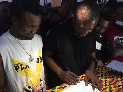 • Mr Ntiamoah (right) and Ashie signing the fight contract