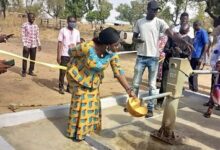 • Ms Diorotey cutting the tape to commission the borehole. With her include Apostle Tackie (immediate right)