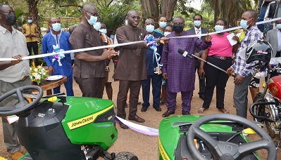 Inset; Mr Martin Adjei Mensah Akorsah(middle) cutting the tape to officially handover the vehicles and other items. Photo. Vincent Dzatse