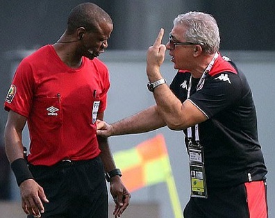 Tunisia coach Kebaier (right) challenges Referee Sikazwe for ending the game before time