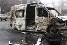 • A burnt minibus is pictured in Almaty, Kazakhstan's main city