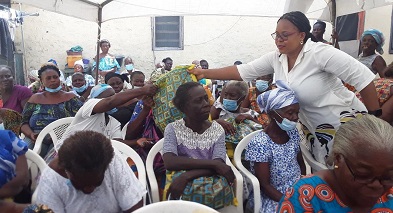 Ms Garglo (right) distributing the items to the beneficiaries