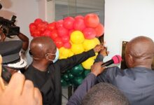 Inset: Mr Ambrose Dery (left) and Mr Samuel Amo Tobbin cutting the tape to open the edifice. Photo: Ebo Gormanand