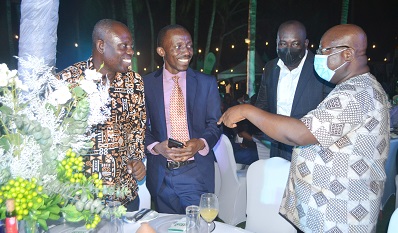 Dr John Mensah (left) interacting with customers at the programme