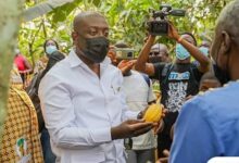 Mr Kojo Oppong Nkrumah launching the chocolate day with a cocoa pod.