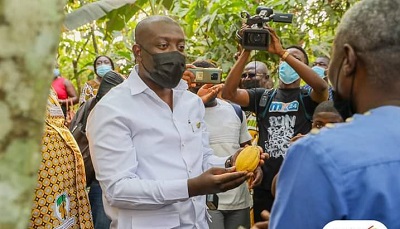 Mr Kojo Oppong Nkrumah launching the chocolate day with a cocoa pod.