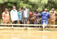 Ms Cecilia Dapaah checking the quality of the water at the Nsawam treatment plant. With her are officials from the GWCL. Photo. Ebo Gorman