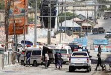 Somali security forces secure the road leading to the scene of an explosion