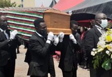 pall bearers conveying the casket away