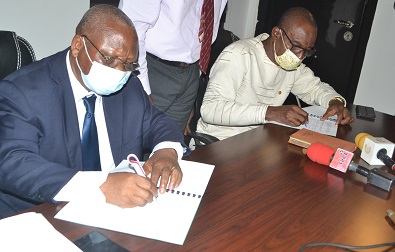 • Prof Ahiawodzi (left) and Mr Monney appending their signatures on the documents Photo: Victor A. Buxton