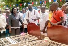 Mr Annor Dompre (4th from right) handing over the beds to Mrs Abuaku