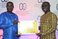 Mr Asare (left) receiving his award from Mr Jerry Boachie-Danquah, Head Marketing and PR Ghana Stock Exchange