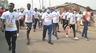 Mr Ashitey (middle) and other participants walking at Tema New Town during the launch