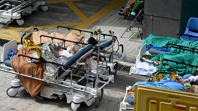 Patients are being treated in makeshift open-air spaces outside overcrowded hospitals