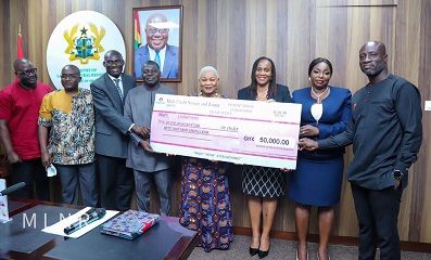 Mr Aninkorah (3rd from left) presenting the dummy cheque to members of the Committee