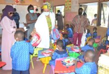 Hajia Adams Kuta (middle) presenting bags to the new pupils at one of the schools visited Photo Victor A Buxton