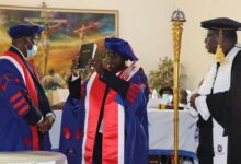 Prof. Oduro-Owusu being sworn into office by the Moderator of the PCG