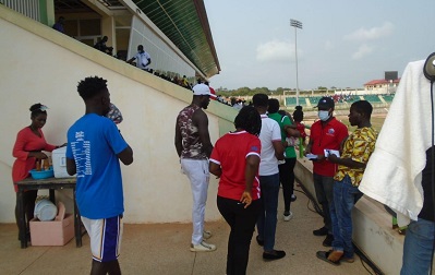 Official of the PURC handing over a leaflet of PURC to the supporters