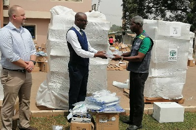 Officials of ADRA donating the items one of the beneficiaries