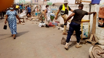 Some traders at circle clearing rubbish during the exercise .Photo. Ebo Gorman