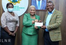 Dr Joyce Aryee(middle) receiving the cheque