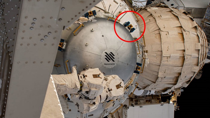 SEAQUE will be hosted on the International Space Station by the Nanoracks Bishop airlock. The blue-and-gold brackets attached to the side of the airlock are for external payloads. The technology demonstration will be installed at one of those sites. Credits: NASA