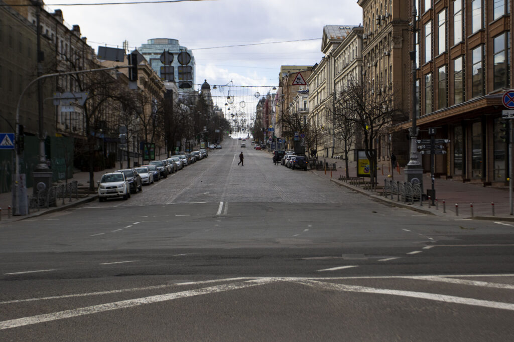 A man walks across what would normally be a busy road during the curfew in Kyiv, Ukraine, on March 27. (Ty O'Neil/SOPA Images/LightRocket/Getty Images)