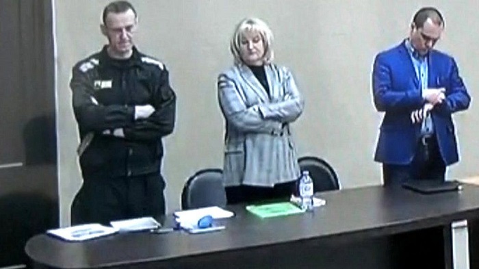 CRITIC- Navalny (left) stood in the makeshift court in Pokrov jail as the verdict was read out