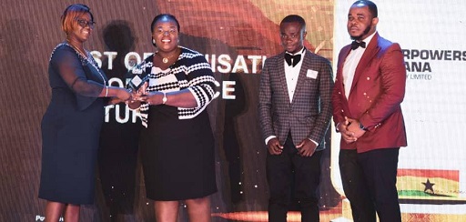 Dorcas Bonney, Assistant HR of Karpower (third right) receiving the award, while some staff of Karpower look on.