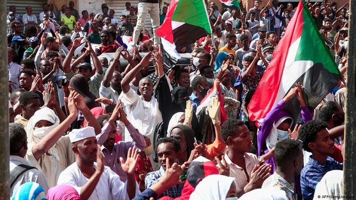 Protesters including many young women and girls march towards the Presidential Palace in Sudan