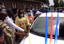 (Inset)Ms Elizabeth Sackey(third from left) being assisted by Mr Charles Adu Asinor ( second from left) to cut the tape to inaugurate the vehicle Photo Michael Ayeh