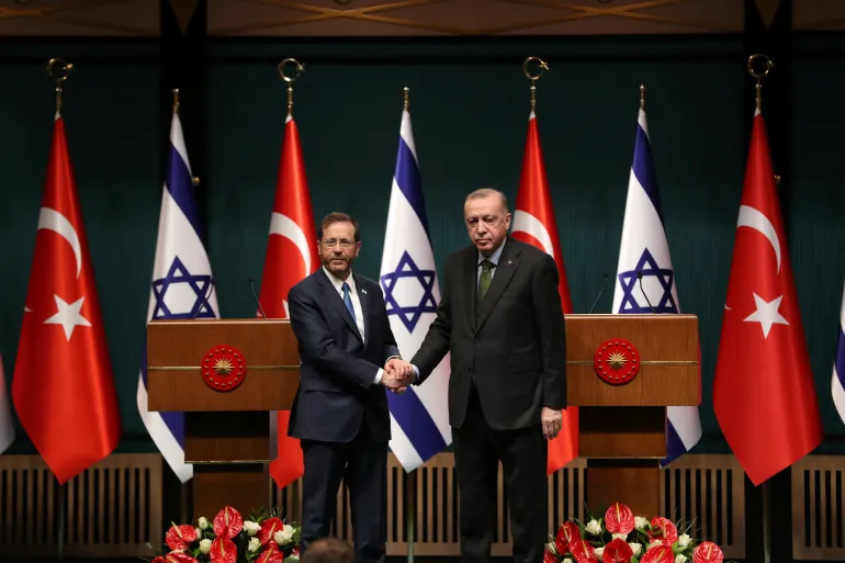 Turkish President, Tayyip Erdogan, right, and his Israeli counterpart, Isaac Herzog, shake hands during a joint news conference in Ankara, Turkey