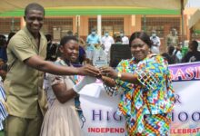 Ms Owusu-Ahenkorah(right) presenting the overall best prize to a pupil of Abelenkpe Basic school