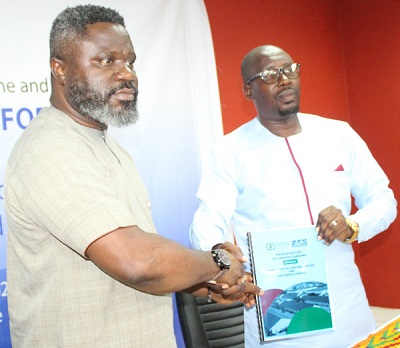 Mr Kwadwo Baah Agyemang (left) and Mr Prince M. Zakaria showing the MoU document after signing.Photo Ebo Gorman